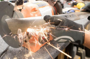 sharpening a lawn mower blade by machine