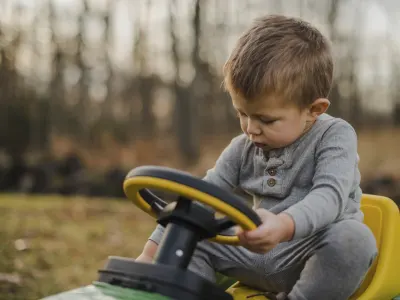 Little boy on a toy tractor
