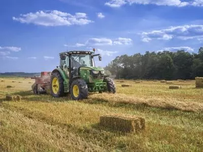 Tractor collecting hay