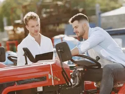 two people on tractor