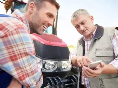 Two people discussing about a tractor