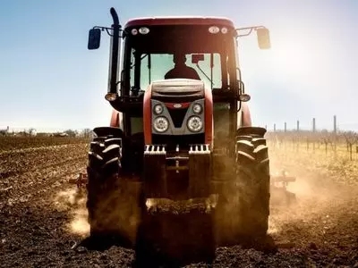 Tractor on a field with the sun shining