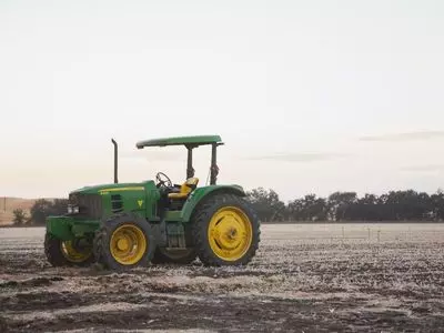 Green John Deer tractor in a field