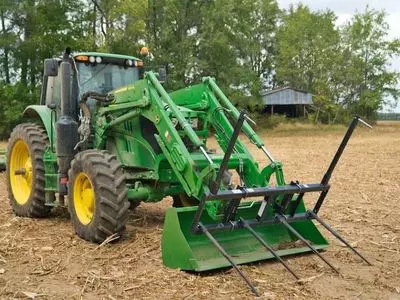 Green John Deere tractor with shovel